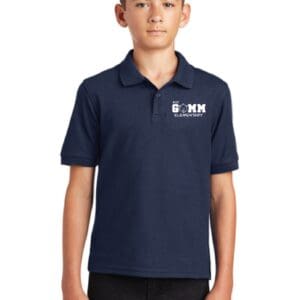 A boy wearing a navy blue polo shirt.