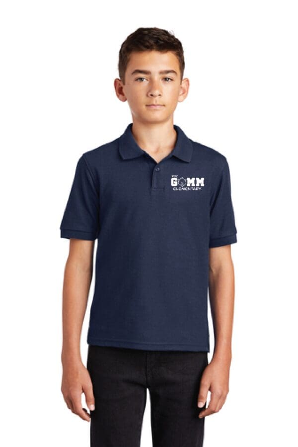 A boy wearing a navy blue polo shirt.